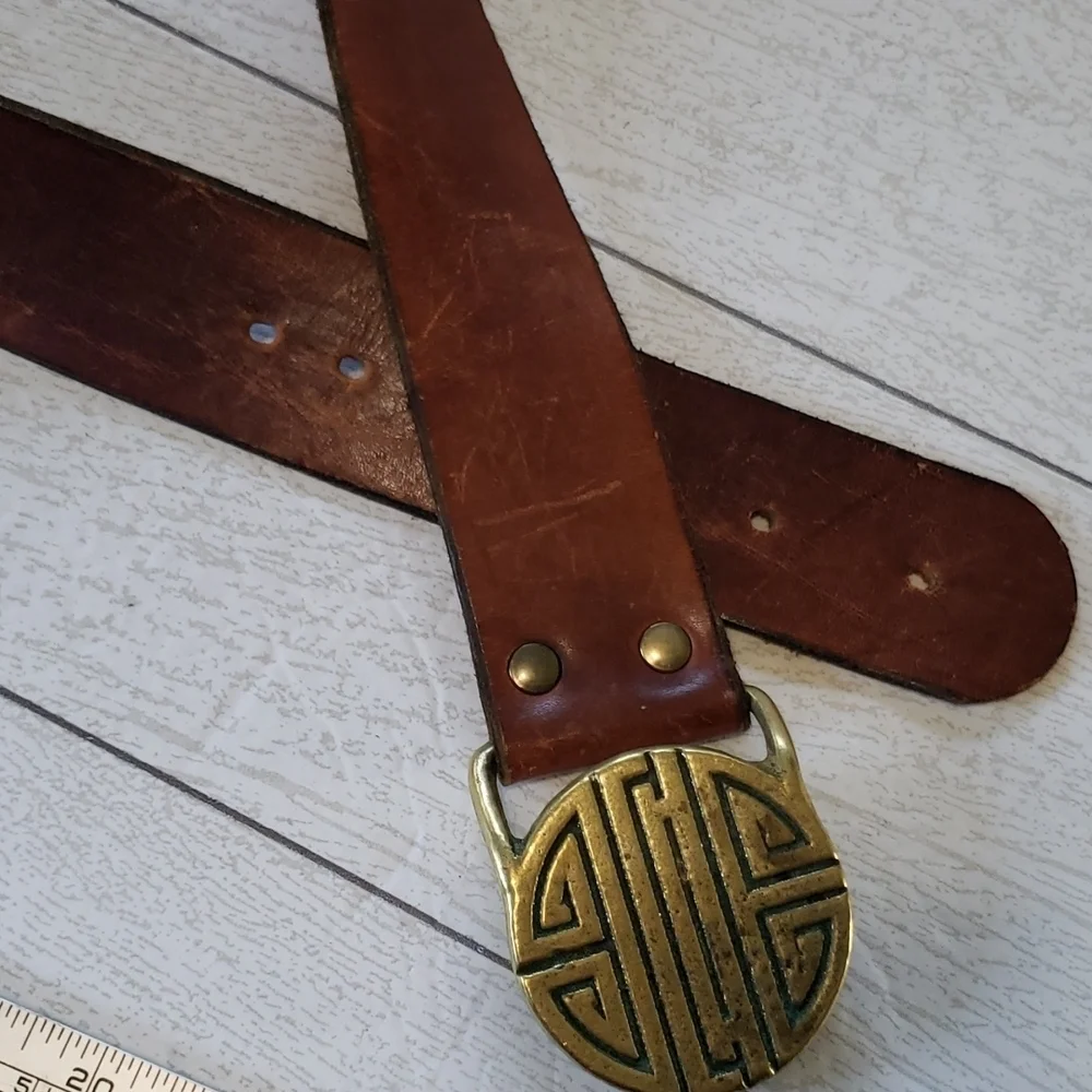 Compared to what brown leather strap with gold buckle